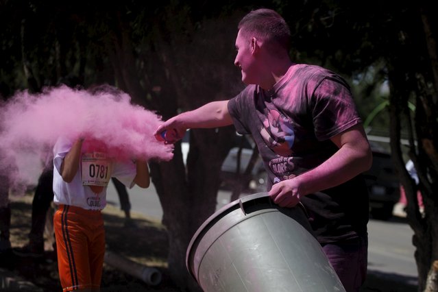 Pink powder is sprayed over a participant as he competes in The Color Run in Ciudad Juarez, Mexico, April 24, 2016. (Photo by Jose Luis Gonzalez/Reuters)