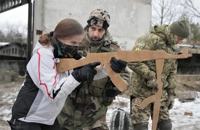 Members of Ukraine's Territorial Defense Forces, volunteer military units of the Armed Forces, train close to Kyiv, Ukraine, Saturday, January 29, 2022. Dozens of civilians have been joining Ukraine's army reserves in recent weeks amid fears about Russian invasion. (Photo by Efrem Lukatsky/AP Photo)