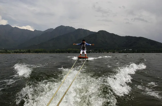 An Indian tourist enjoys water skiing on the waters of Dal Lake in Srinagar June 10, 2012. (Photo by Fayaz Kabli/Reuters)