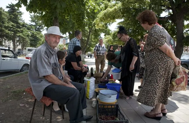 Vendors sell food stuffs in a street in Tskhinvali, the capital of the breakaway region of South Ossetia, Georgia, July 6, 2015. (Photo by Kazbek Basaev/Reuters)