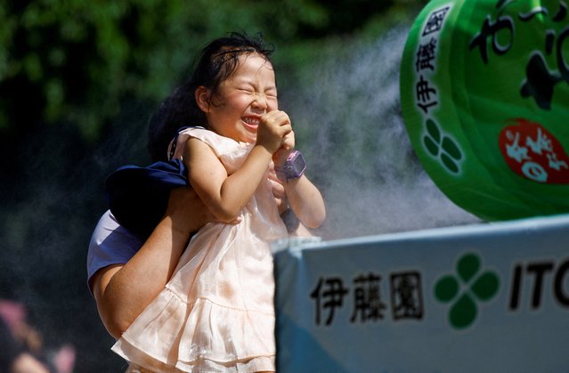 A child reacts as a family takes a break next to a cooling mist at the Sensoji temple as Japanese government issued heat stroke alerts in 39 of the country's 47 prefectures in Tokyo, Japan on July 22, 2024. (Photo by Issei Kato/Reuters)