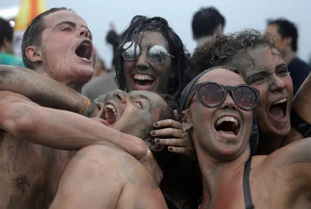 Festival-goers enjoy the mud during the annual Boryeong Mud Festival at Daecheon Beach on July 18, 2015 in Boryeong, South Korea. The mud, which is believed to have benefical effects on the skin due to its mineral content, is sourced from mud flats near Boryeong and transported to the beach by truck. (Photo by Chung Sung-Jun/Getty Images)