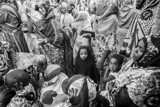 “Little girl at wedding in Africa”. I happened to attend to a local African wedding. In Africa during weddings little girls are dressed like adult women and wear make-up. According to the local tradition the make-up is used to get rid of evil spirits. Photo location: Tanzania. (Photo and caption by Barbara Di Maio/National Geographic Photo Contest)