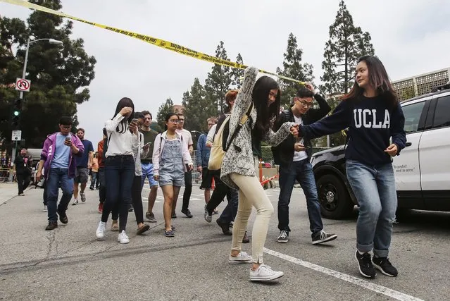 Students leave the scene after a fatal shooting at the University of California, Los Angeles, Wednesday, June 1, 2016, in Los Angeles. (Photo by Ringo H.W. Chiu/AP Photo)