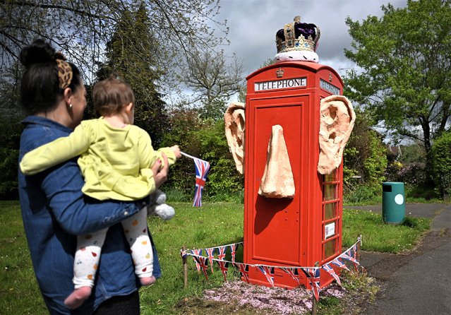 A refurbished telephone call box decorated with the ears and crown of King Charles III, is pictured in the village of Compton, Surrey, west of London, on May 5, 2023, ahead of the coronation weekend. The country prepares for the coronation of Britain's King Charles III and his wife Britain's Camilla, Queen Consort on May 6, 2023. (Photo by Paul Ellis/AFP Photo)