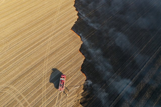 An aerial view shows firefighters extinguish stubble fire in Edirne, Turkiye on August 17, 2024. (Photo by Gokhan Balci/Anadolu via Getty Images)