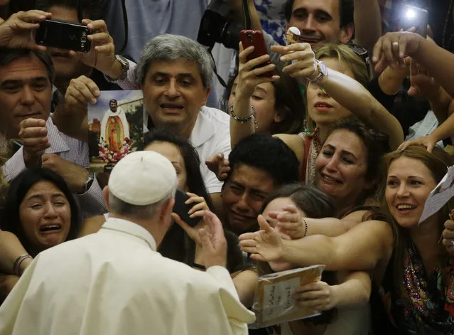 Pope Francis is cheered by faithful as he arrives in the Paul VI hall at the Vatican, Wednesday, August 5, 2015. (Photo by Gregorio Borgia/AP Photo)