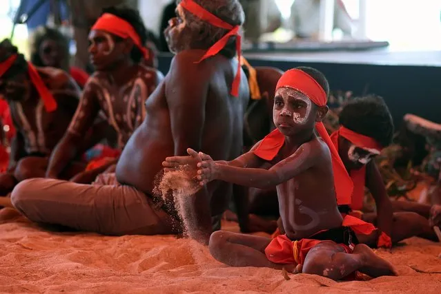 A young aboriginal dancer plays in the sand during the Kenbi Native land claim ceremony, near Darwin, Northern Territory, Australia, 21 June 2016. Australian Prime Minister Malcolm Turnbull is in Darwin to attend the deed handover ceremony settling Australia's oldest Aboriginal land rights claim. (Photo by Lukas Coch/EPA)