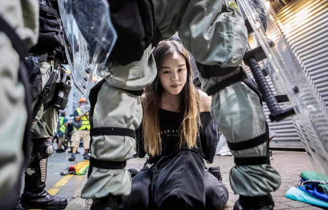 A young female demonstrator is arrested by police during clashes in the Causeway Bay area of Hong Kong, China on October 6, 2019. Hundreds of thousands of protesters marched through the city's streets in defiance of the new “no-mask” law, which was introduced two days ago as demonstrations roll into a 14th week. (Photo by Rick Findler/EPA/EFE/Rex Features/Shutterstock)