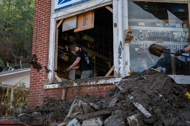 Volunteers with Operation Allies Refuge Foundation shovel debris and mud out of Whitson Furniture and General Store in Green Mountain, North Carolina, October 6, 2024, in the aftermath of Hurricane Helene. Whitson Furniture and General Store is 64 year old small family business The storm, which struck Florida on September 26, has killed more than 225 people across a handful of states – making it the deadliest natural disaster to hit the United States since 2005's Hurricane Katrina – with the toll still rising. (Photo by Allison Joyce/AFP Photo)