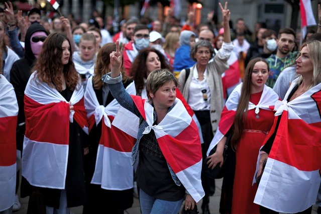 People carrying historical white-red-white flags of Belarus take part in Belarusians' march through Warsaw, on the third anniversary of the 2020 presidential election which was followed by mass protests over alleged electoral fraud, in Warsaw, Poland on August 9, 2023. (Photo by Kacper Pempel/Reuters)