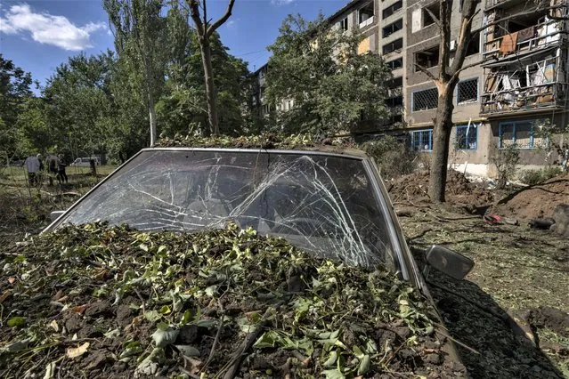 A damaged car in the aftermath of a missile strike in Konstantinovka, in Donetsk Oblast, eastern Ukraine, Friday, July 15, 2022. (Photo by Nariman El-Mofty/AP Photo)