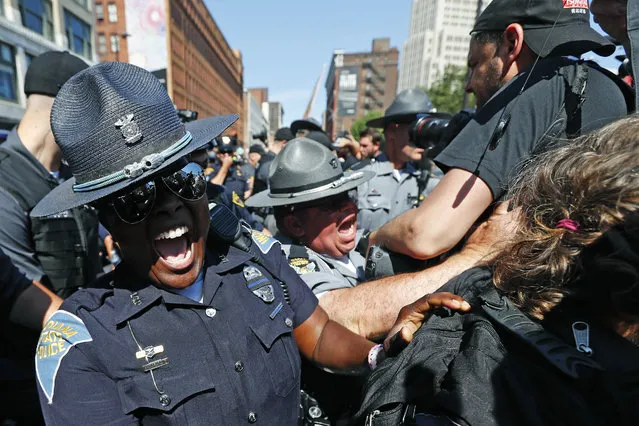 Law enforcement officers clash with protesters, Wednesday, July 20, 2016, in Cleveland, during the third day of the Republican convention. (Photo by John Minchillo/AP Photo)