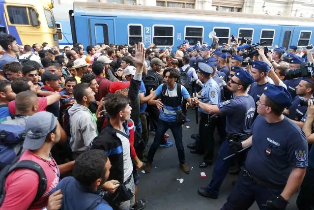Migrants face Hungarian police in the main Eastern Railway station in Budapest, Hungary, September 1, 2015. (Photo by Laszlo Balogh/Reuters)