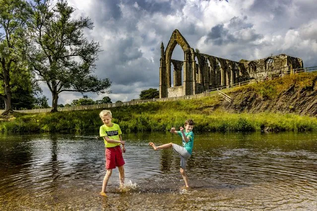 Brothers Daniel and Vincent van der Noort, from the Netherlands, play at Bolton Abbey, North Yorkshire, while on holiday on July 26, 2022. (Photo by James Glossop/The Times)