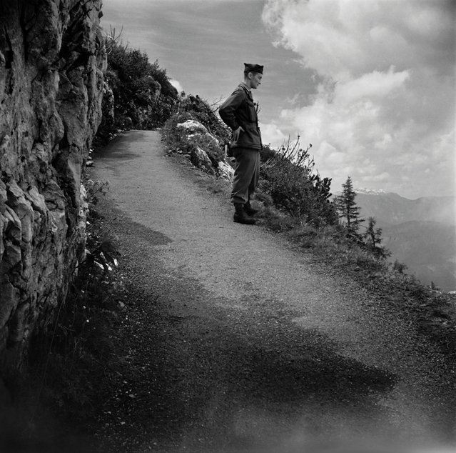 Photo taken on May 4, 1945 shows a US soldier on the way to the Berghof, Adolf Hitler's home, in the Obersalzberg of the Bavarian Alps near Berchtesgaden, Bavaria. Rebuilt, much expanded and renamed in 1935, the Berghof was Hitler's vacation residence for ten years. In late April 1945 the house was damaged by British aerial bombs, set on fire by retreating SS troops in early May, and looted after Allied troops reached the area. The Bavarian government demolished the burnt shell in 1952. (Photo by Eric Schwab/AFP Photo)