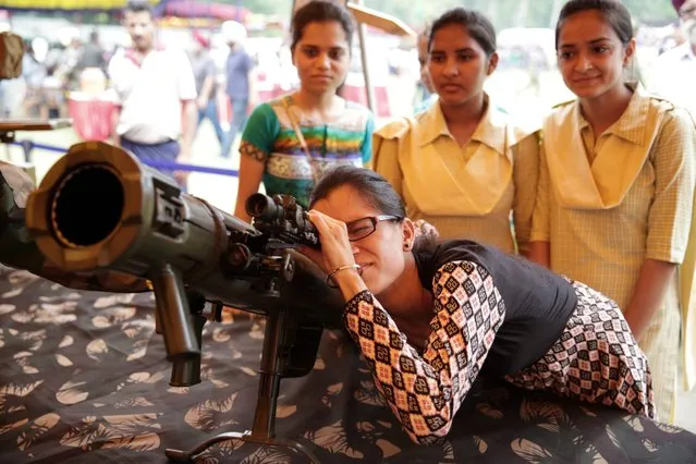 A young Indian girl takes aim with a rocket launcher during “Know Your Army” exhibition at the Amritsar Cantonment area in Amritsar, India, 10 August 2016. The arms and ammunition exhibition has been organized by the Indian Army with the aim of showcasing Indian Army equipment, ethos, culture and to motivate youngsters to choose a career in the army, as “A Way of Life”. The exhibition will run from 10 to 16 August. (Photo by Raminder Pal Singh/EPA)