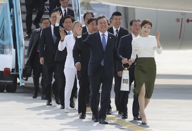 South Korean Minister of Culture, Sports and Tourism Do Jong-whan, front left, and former South Korean Olympic figure skating champion Yuna Kim, right, hold the Olympic flame upon arrival at Incheon International Airport in Incheon, South Korea, Wednesday, November 1, 2017. South Korea's Pyeongchang is the host city of the 2018 Winter Olympics which will be held from Feb. 9 to Feb. 25. (Photo by Lee Jin-man/AP Photo)