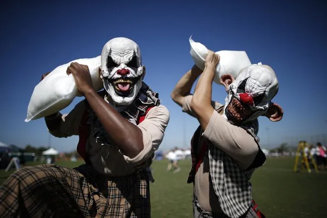 Michael Johnson, 22, (L) and William Rountree, 22, strike a pose before joining people fighting for a minute to break the Guinness World Record for the largest pillow fight, with 4,200 pillows at the University of California, Irvine in Irvine, California September 30, 2014. (Photo by Lucy Nicholson/Reuters)