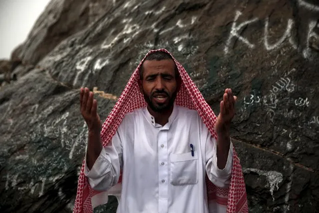 A Muslim pilgrim prays as he visits Hera cave, where Muslims believe Prophet Mohammad received the first words of the Koran through Gabriel, at the top of Mount Al-Noor during the annual haj pilgrimage in the holy city of Mecca, September 21, 2015. (Photo by Ahmad Masood/Reuters)