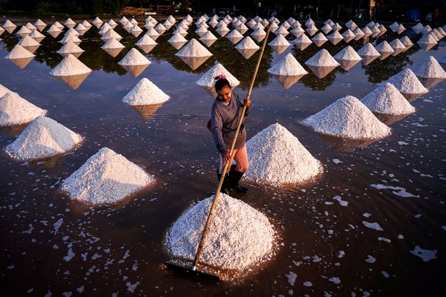 A worker collects sea salt at a salt farm in Chachoengsao province, on the outskirts of Bangkok, Thailand, on March 15, 2025. (Photo by Athit Perawongmetha/Reuters)