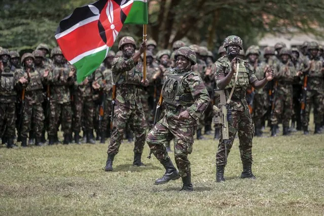 A member of the Kenya Defence Forces (KDF) dances during a flag-handover ceremony, ahead of a future deployment to eastern Congo as part of the newly-created East African Community Regional Force (EACRF), at the Embakasi garrison in Nairobi, Kenya Wednesday, November 2, 2022. Kenya is sending more than 900 military personnel to eastern Congo to join a new regional force trying to calm deadly tensions fueled by armed groups that have led to a diplomatic crisis between Congo and neighboring Rwanda. (Photo by Brian Inganga/AP Photo)