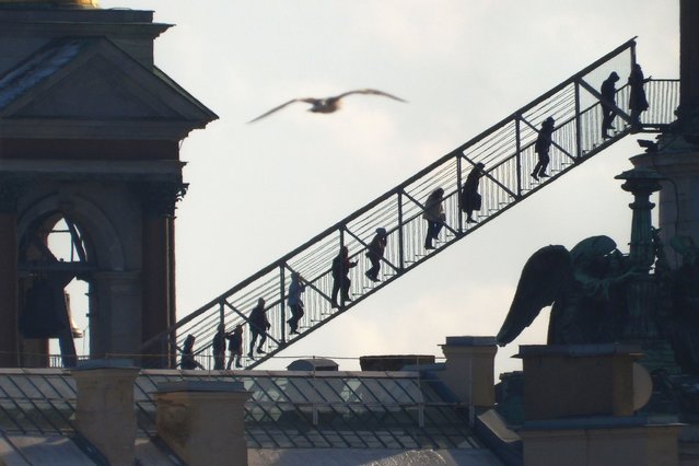 People climb to the observation deck on the colonnade of St. Isaac's Cathedral in central St. Petersburg, Russia, Saturday, March 15, 2025. (Photo by Dmitri Lovetsky/AP Photo)