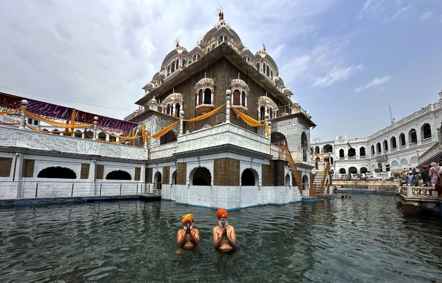 Sikh pilgrims take a holy dip at the Gurdwara Panja Sahib in Hassan Abdal, Pakistan, 16 April 2025. The Sikh community celebrates the Baisakhi festival annually to mark the wheat harvest and the spring season. This year, the Pakistani High Commission issued more than 6,500 visas to Indian pilgrims to participate in the festival.  (Photo by Sohail Shahzad/EPA)