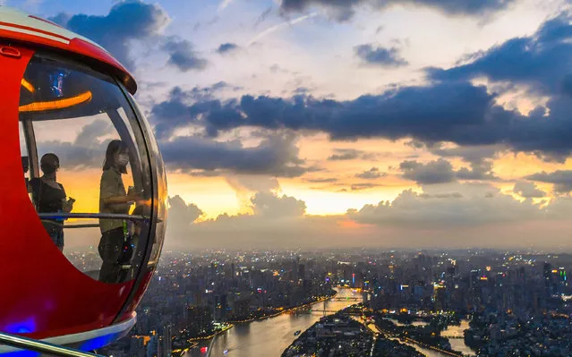 Photo taken at the top of the Canton Tower, a landmark in Guangzhou, on August 7, 2022 shows the Pearl River running through downtown of Guangzhou, capital of south China's Guangdong Province. (Photo by Liu Dawei/Xinhua News Agency)