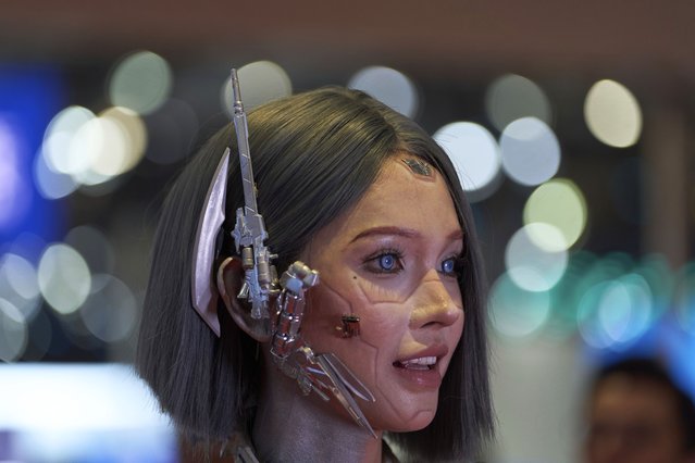 A vlogger who dressed up to look like a humanoid robot reacts at the Shanghai auto show on Thursday, April 24, 2025. (Photo by Ng Han Guan/AP Photo)
