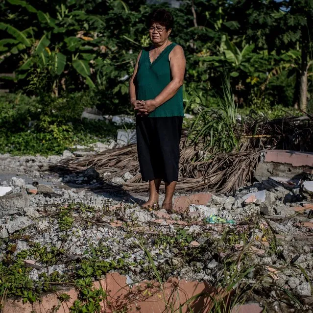 Typhoon Haiyan survivor Maria Canamaso stands amongst the ruins of her home on November 6, 2014 in San Antonio, Samar, Philippines. Maria does not plan to rebuild her home as it is now located in a No Build Zone she has relocated to another location a few streets away and is working on building a new house. (Photo by Chris McGrath/Getty Images)