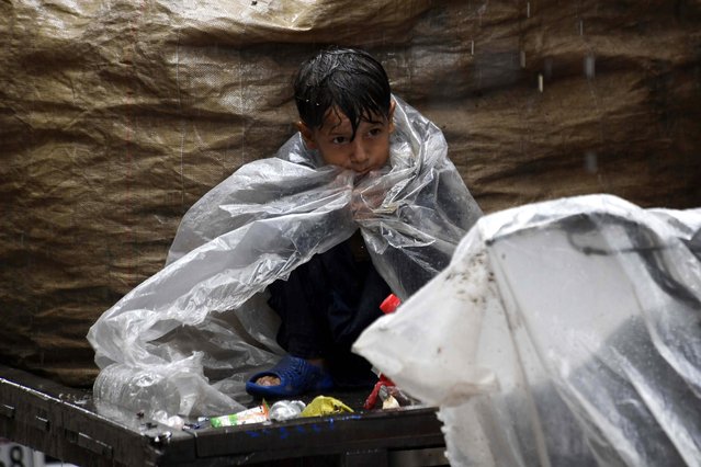 A Pakistani boy sits on a cart amid rainfall in Karachi, Pakistan, 27 June 2025. Heavy monsoon rains have impacted major cities across Pakistan, triggering urban flooding and power outages. Authorities remain on high alert. (Photo by Shahzaib Akber/EPA)
