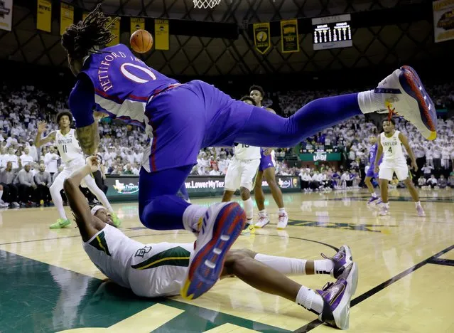Bobby Pettiford Jr. #0 of the Kansas Jayhawks passes the ball after colliding with Flo Thamba #0 of the Baylor Bears in the first half at Ferrell Center on January 23, 2023 in Waco, Texas. (Photo by Tom Pennington/Getty Images)