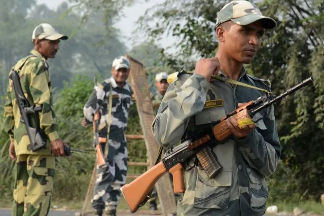 Indian Border Security Force (BSF) personnel stand guard at the India-Pakistan Wagah Border, about 35 km from Amritsar on September 29, 2016, after the Punjab state government issued a warning to villagers to evacuate from a 10 km radius from the India-Pakistan border. Indian commandos carried out a series of lightning strikes September 29 along the de facto border with Pakistan in Kashmir, provoking furious charges of “naked aggression” from its nuclear-armed neighbour. (Photo by Narinder Nanu/AFP Photo)