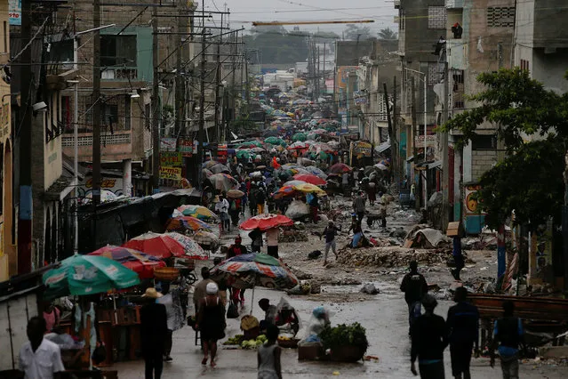 Vendors sell their goods on the street while Hurricane Matthew approaches in Port-au-Prince, Haiti October 3, 2016. (Photo by Carlos Garcia Rawlins/Reuters)