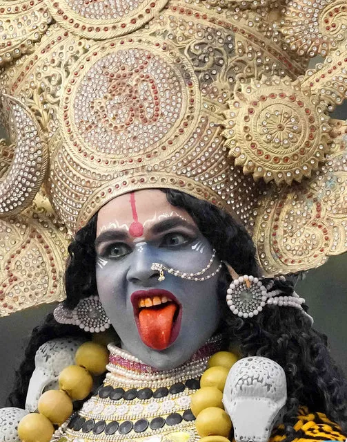 A devotee dressed as Hindu goddess Kali participates in a procession on the eve of Shivratri festival in Jammu, India, Friday, February 17, 2023. The festival dedicated to the worship of Shiva, will be marked across the country on Saturday. (Photo by Channi Anand/AP Photo)