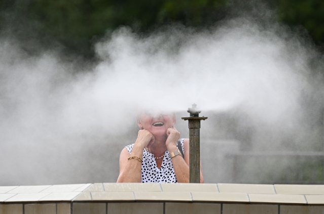 A woman enjoys a brine atomizer at the brine-inhalation park in the spa gardens in Bad Kreuznach, Germany, on July 15, 2025. (Photo by Arne Dedert/picture alliance via Getty Images)