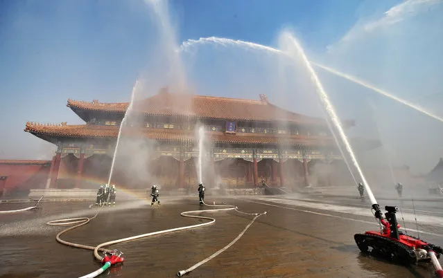 Firefighters spray water during a fire drill at the Forbidden City in Beijing, China, October 10, 2016. (Photo by Reuters/Stringer)