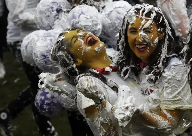 Students from St Andrews University are covered in foam as they take part in the traditional “Raisin Weekend” in the Lower College Lawn, at St Andrews in Scotland, Britain October 17, 2016. The weekend, which begins on Sunday, involves rituals for new students, culminating in a foam fight on Monday morning. (Photo by Russell Cheyne/Reuters)