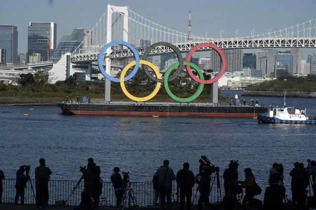 The Olympic Symbol is reinstalled after it was taken down for maintenance ahead of the postponed Tokyo 2020 Olympics in the Odaiba section Tuesday, December 1, 2020, in Tokyo. (Photo by Eugene Hoshiko/AP Photo)