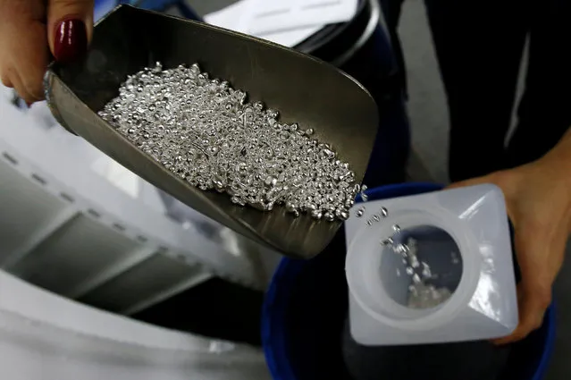 An employee packs granules of 99.99 percent pure silver at the Krastsvetmet non-ferrous metals plant, one of the world's largest producers in the precious metals industry, in the Siberian city of Krasnoyarsk, Russia October 24, 2016. (Photo by Ilya Naymushin/Reuters)