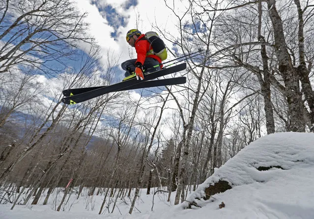 In this Saturday, April 21, 2018, photo, Andrew Drummond “sends” a large rock while skiing in the glades on Crescent Ridge in the Randolph Community Forest in Randolph, New Hampshire. (Photo by Robert F. Bukaty/AP Photo)