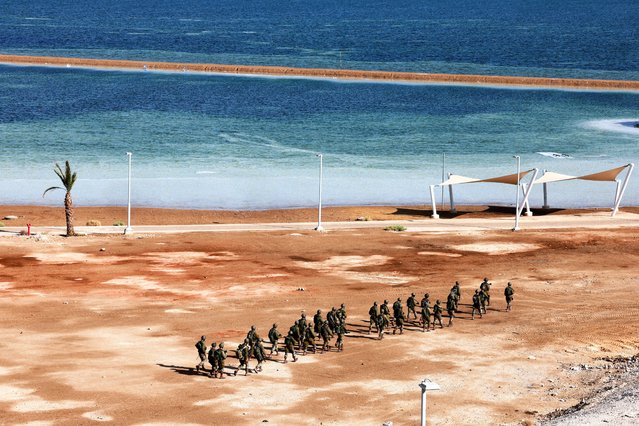 Israeli military members walk next to the Dead Sea near the scene of a shooting attack after Israel's military said it identified attackers crossing from Jordan, in southern Israel, on October 18, 2024. (Photo by Ammar Awad/Reuters)