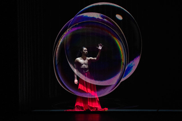 A performer with the dance company of South Korean choreographer Eun-Me Ahn takes part in a dress rehearsal for “Dragons”, a presentation of modern and traditional dance styles from across Asia, which features as part of the Bradford 2025 City of Culture, at the Alhambra Theatre, Bradford, northern England on March 21, 2025. (Photo by Oli Scarff/AFP Photo)
