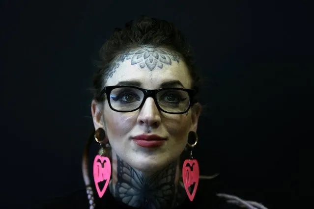 A woman poses for a photograph at the Tattoo Tea Party at the Central Convention Centre in Manchester, Britain on April 9, 2022. (Photo by Lee Smith/Reuters)