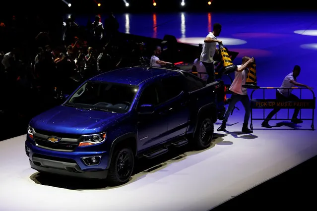 Dancers perform with a Colorado truck shown at a Chevrolet event in Guangzhou, China November 17, 2016. (Photo by Bobby Yip/Reuters)