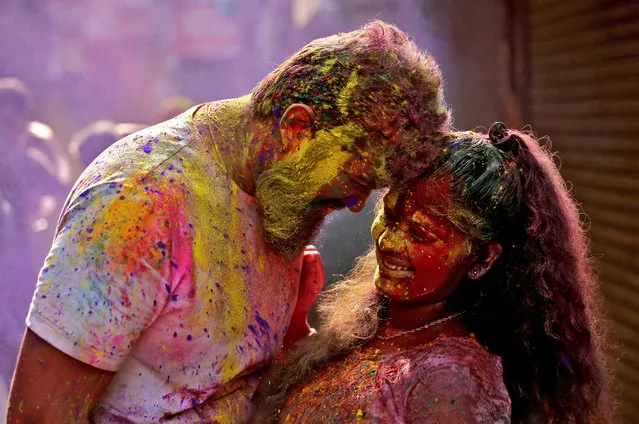 A couple daubed in colours react as coloured powder is thrown at them during Holi celebrations, amidst the spread of the coronavirus disease (COVID-19), in Chennai, India, March 29, 2021. (Photo by P. Ravikumar/Reuters)
