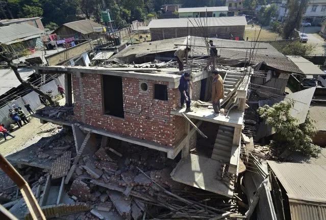 A damaged four-storey building after a  magnitude-6.7 earthquake struck, in Imphal, north-eastern India, 04 January 2016. Five deaths have been reported from in and around Imphal due to falling debris. Imphal has a population of 270,000, and people were jolted from their sleep and ran out of their homes in panic. (Photo by EPA/Stringer)