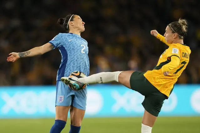 Australia's Steph Catley, right, and England's Lucy Bronze challenge for the ball during the Women's World Cup semifinal soccer match between Australia and England at Stadium Australia in Sydney, Australia, Wednesday, August 16, 2023. (Photo by Abbie Parr/AP Photo)
