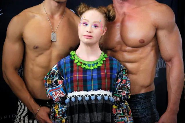 Model Madeline Stuart stands backstage between two male models at New York Fashion Week in New York City, U.S., September 6, 2018. (Photo by Andrew Kelly/Reuters)